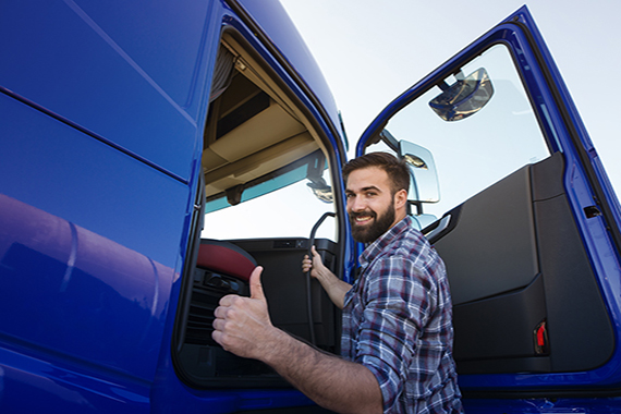 professional-truck-driver-entering-his-truck-long-vehicle-holding-thumbs-up-1-1.jpg